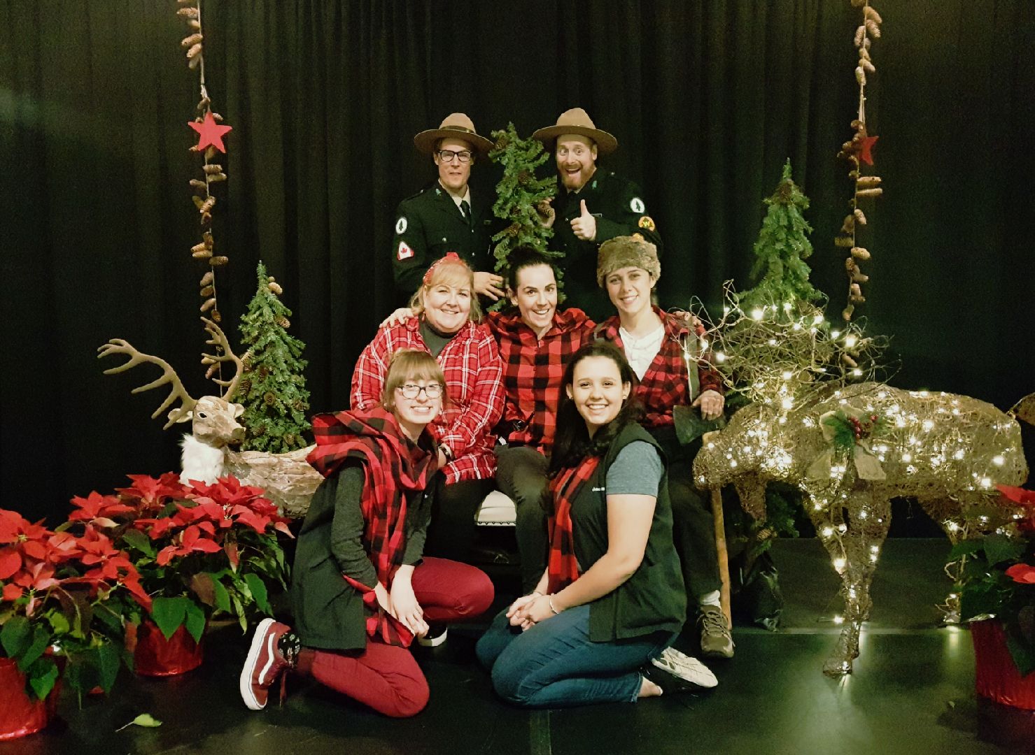 Group of people posing for a photo with a christmas theme
